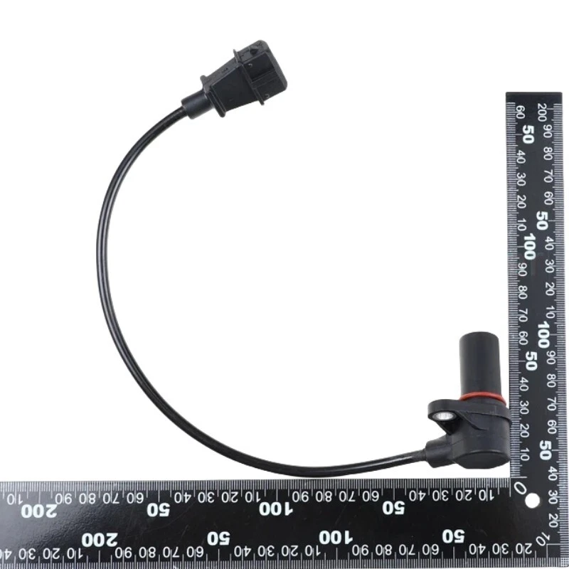 Reference image — crankshaft position sensor 0281002285, complete lead routing and mounting-ear side with source ruler