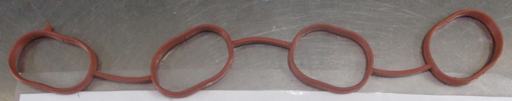 Reference photograph - intake manifold gasket 28411-2B600 - whole linked four-port gasket, plan view