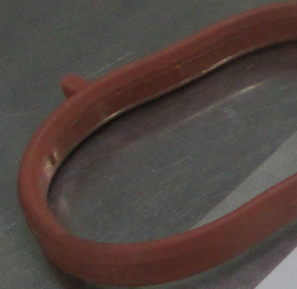 Reference photograph - intake manifold gasket 28411-2B600 - same-photo partial end-tab and inner-lip profile detail