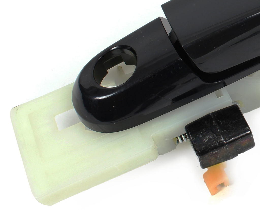 Reference photograph - front-left black exterior door handle with base 82650-2E000 - same-photo keyhole-end housing, base and attachment interface detail