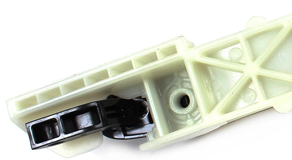 Reference photograph - front-left black exterior door handle with base 82650-2E000 - same-photo opposite pivot end and mounting-boss detail
