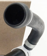 Load image into Gallery viewer, Reference image — right-hand headlamp washer nozzle85207-33030 — native same-photo detail of hose inlet mouth, elbow and clamp; plain source carton remains behind it; external illustration, not actual stock